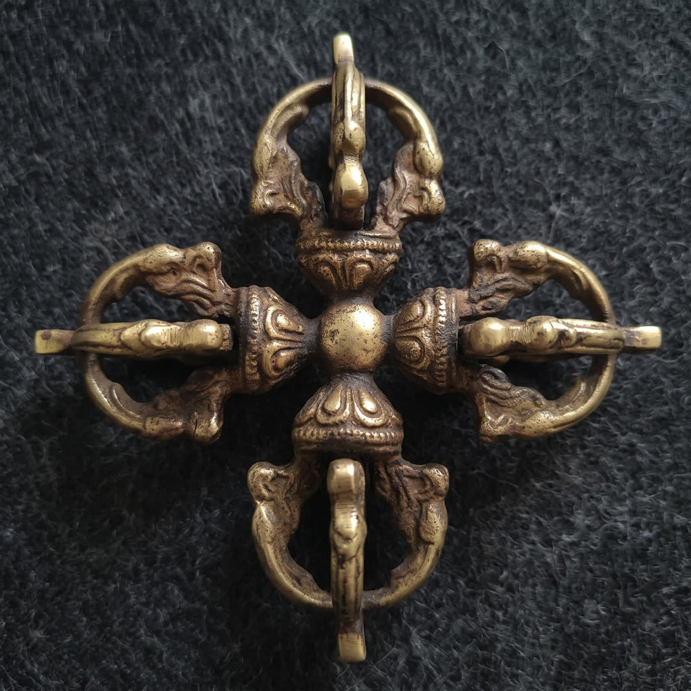Top-down view of the double vajra showing four identical vajra heads around a round center hub