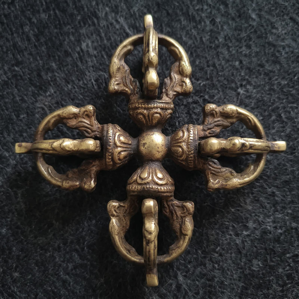 Top-down view of the double vajra showing four identical vajra heads around a round center hub