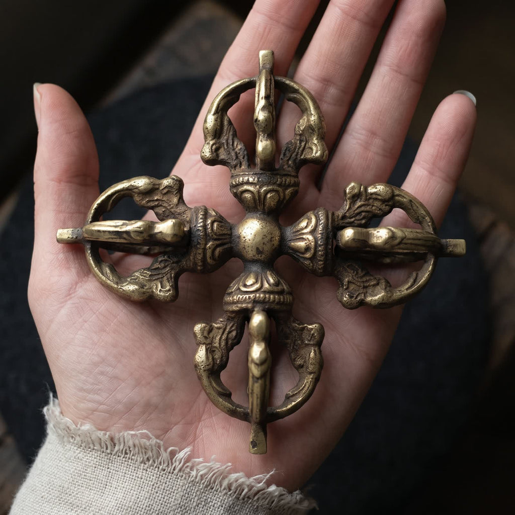 Open palm holding the double vajra to show its size, about 10.5 cm across
