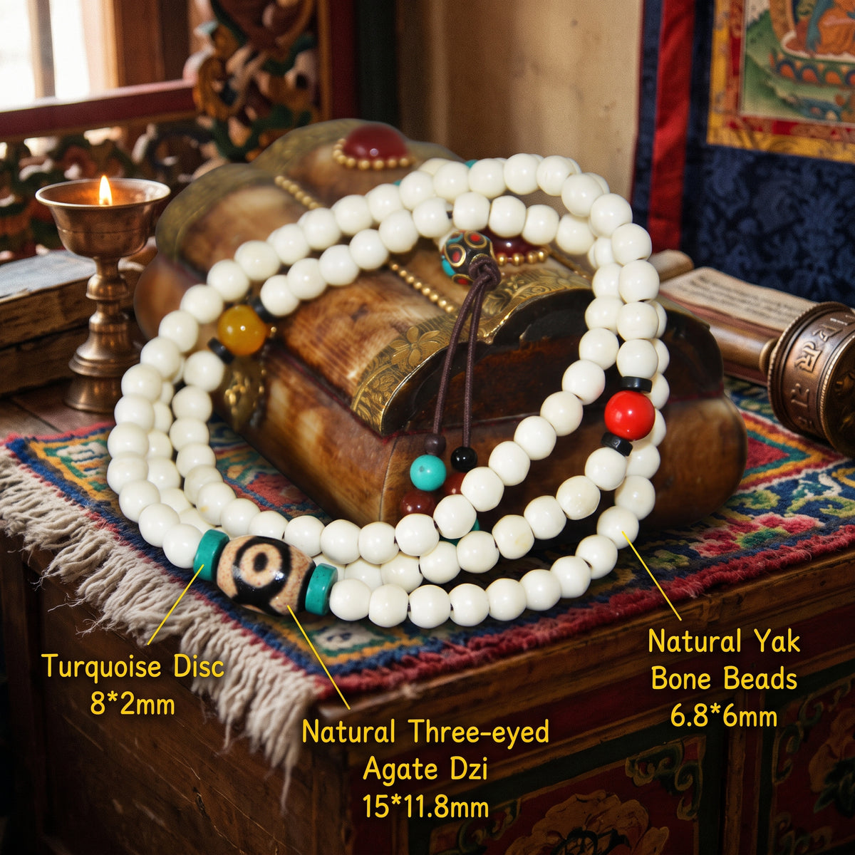 Labeled bone mala on a carved box: yak bone beads 6.8 × 6 mm, turquoise discs and a three-eyed agate dzi