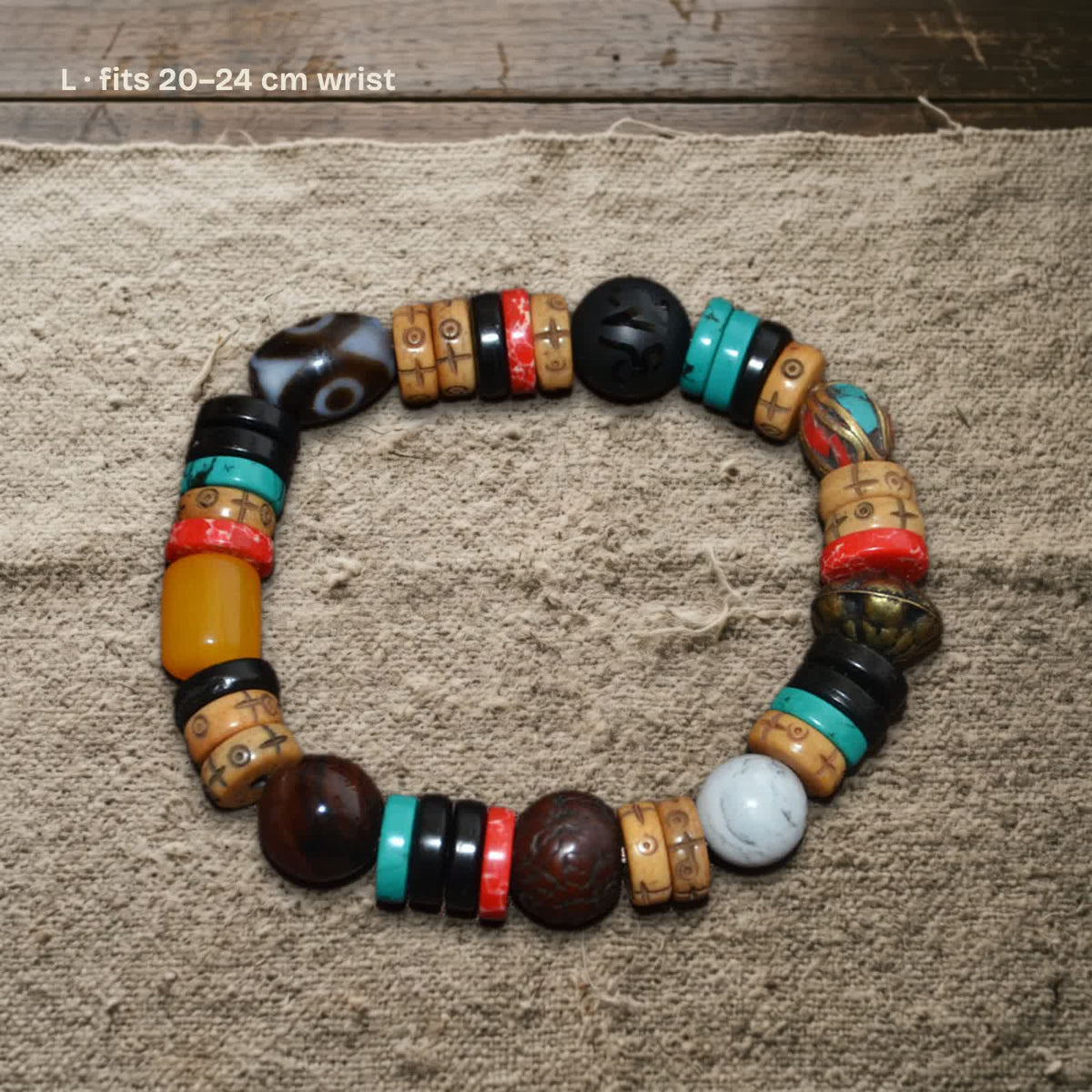 Size L dzi and carved yak bone bracelet on undyed wool, labelled fits 20–24 cm wrist