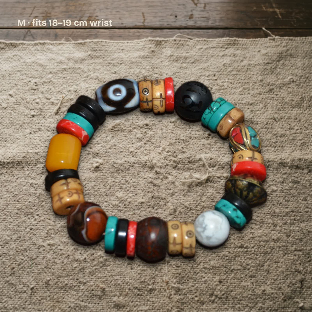 Size M dzi and carved yak bone bracelet on undyed wool, labelled fits 18–19 cm wrist