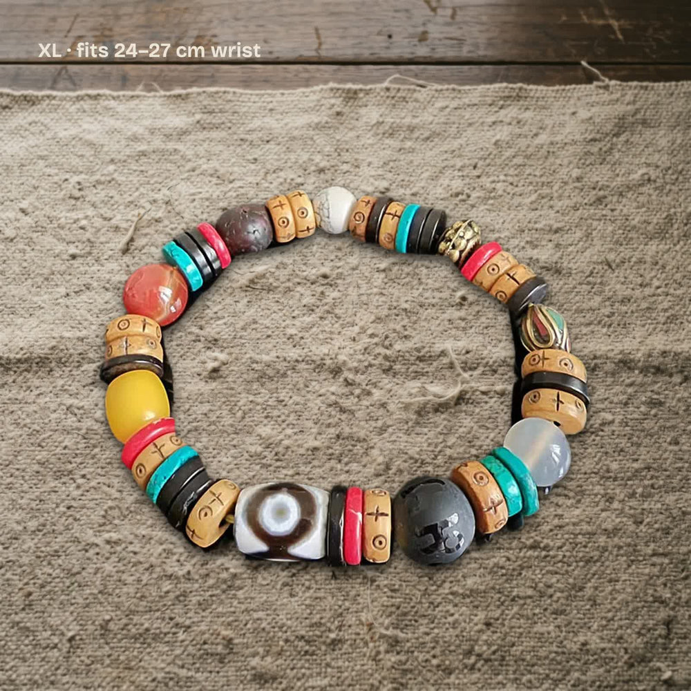 Size XL dzi and carved yak bone bracelet on undyed wool, labelled fits 24–27 cm wrist
