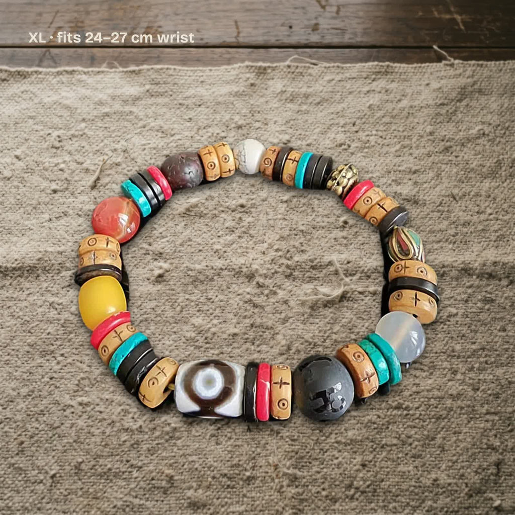 Size XL dzi and carved yak bone bracelet on undyed wool, labelled fits 24–27 cm wrist